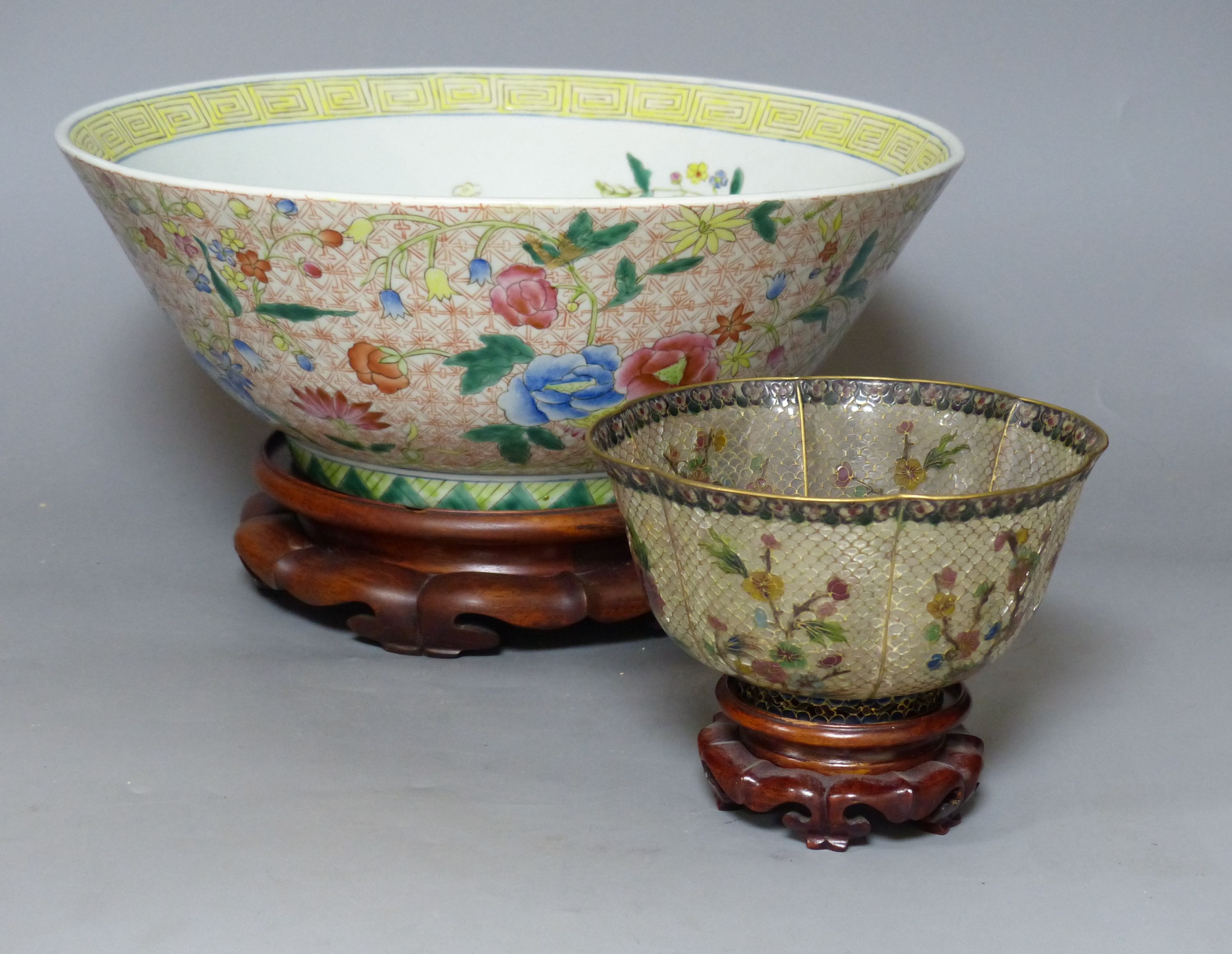 A Chinese plique a jour enamel bowl on stand, and a Chinese famille rose bowl on stand, largest 33cm diameter